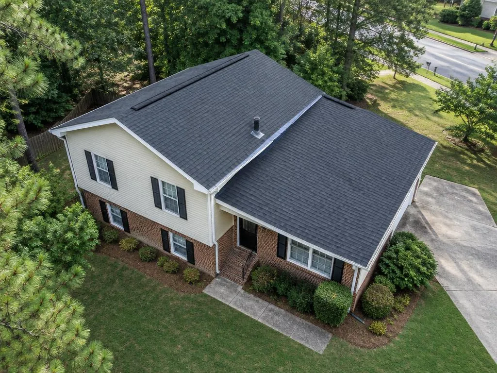 AI aerial illustration of a Georgia-style split-level home with two stepped charcoal gable roofs