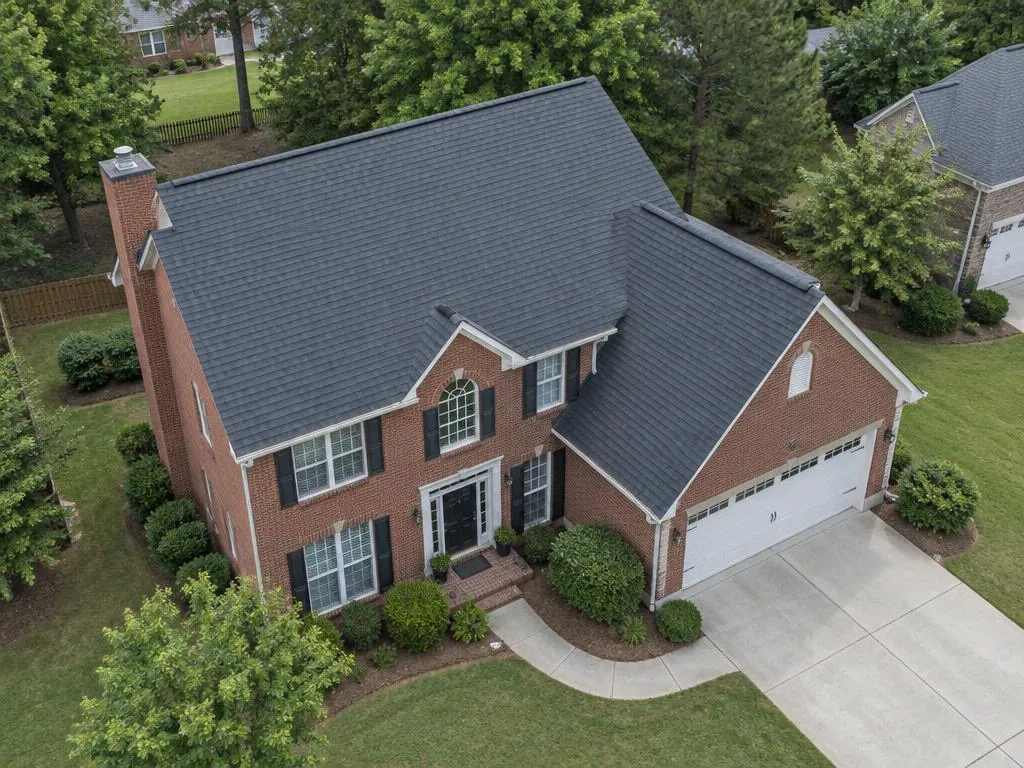 AI aerial illustration of a red brick Georgia-style home with intersecting gray gable roofs